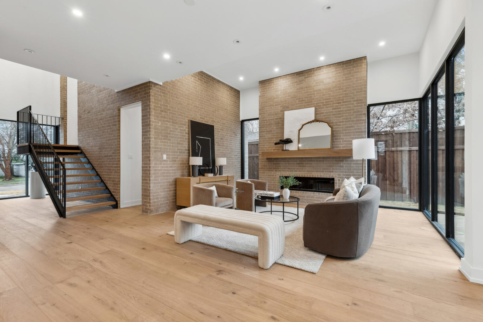 Open living room with fireplace and floor-to-ceiling windows